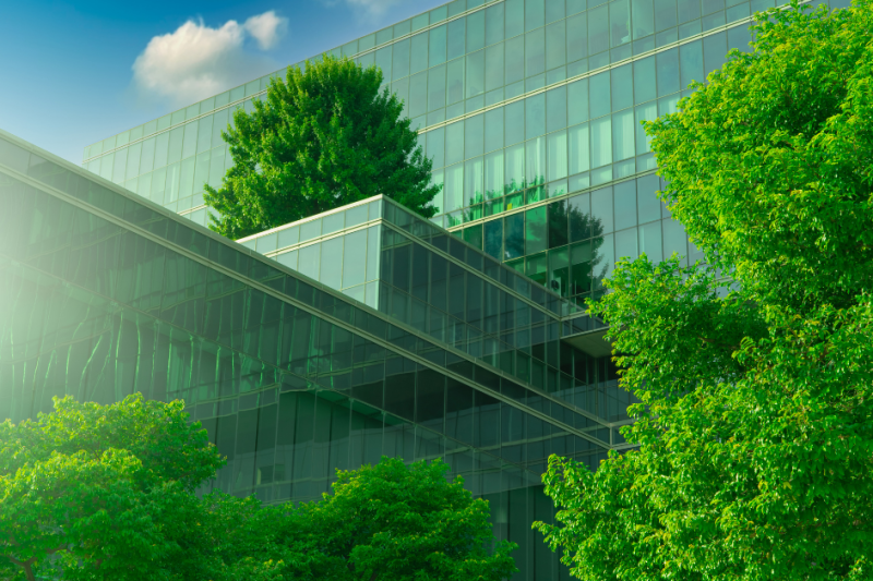 Building with lots of glass windows and trees